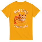 Gold t-shirt printed with Trippi Troppi and the words Nine lives, twelve legs, front view